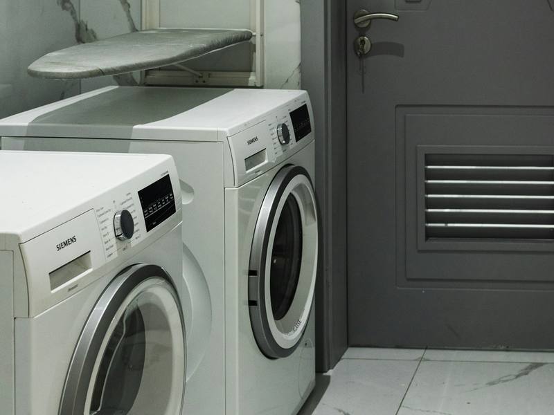 Front-load washer and dryer pair in a laundry room