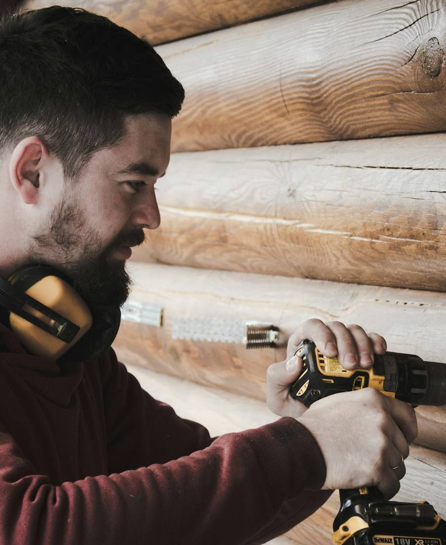 Appliance technician working with a power drill